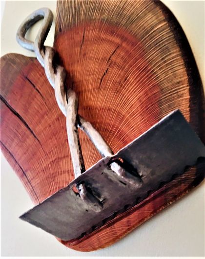 An antique rare tanners hand tool matched with plum wood, original wall art.